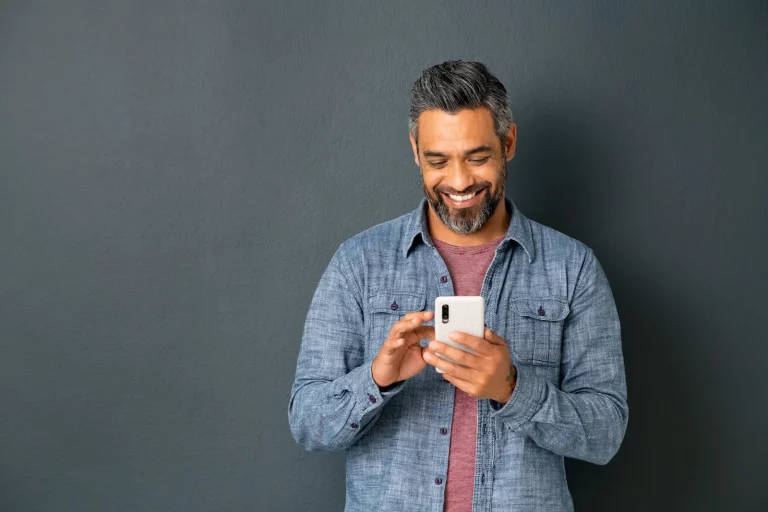 man looking down at his mobile device